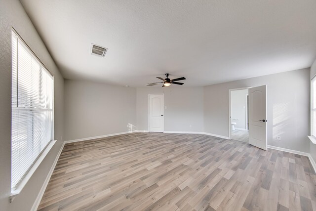 empty room with light wood-type flooring and ceiling fan