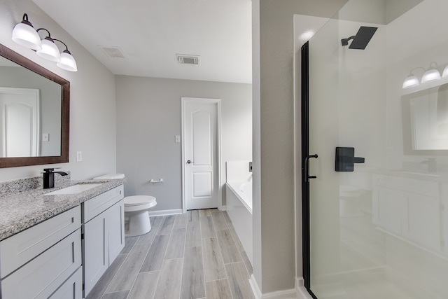 full bathroom with toilet, separate shower and tub, and vanity