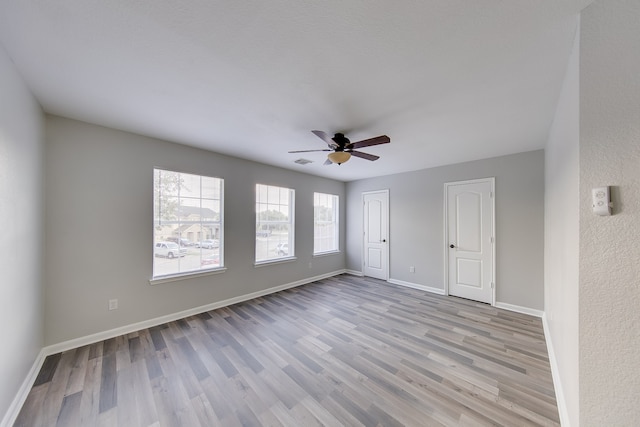 spare room featuring ceiling fan and light wood-type flooring