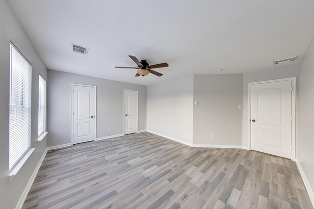 unfurnished room with ceiling fan and light wood-type flooring