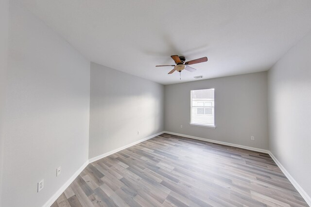 spare room with light hardwood / wood-style flooring and ceiling fan