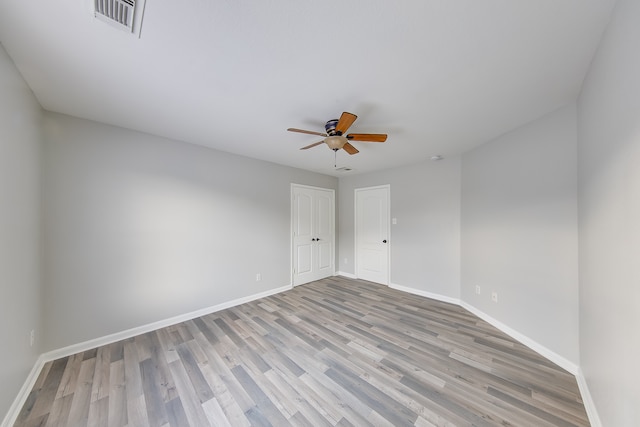 spare room featuring ceiling fan and light wood-type flooring