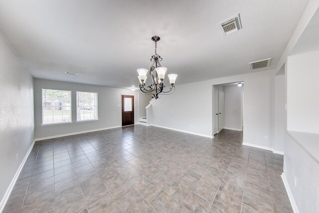 unfurnished room featuring a notable chandelier and light tile patterned floors