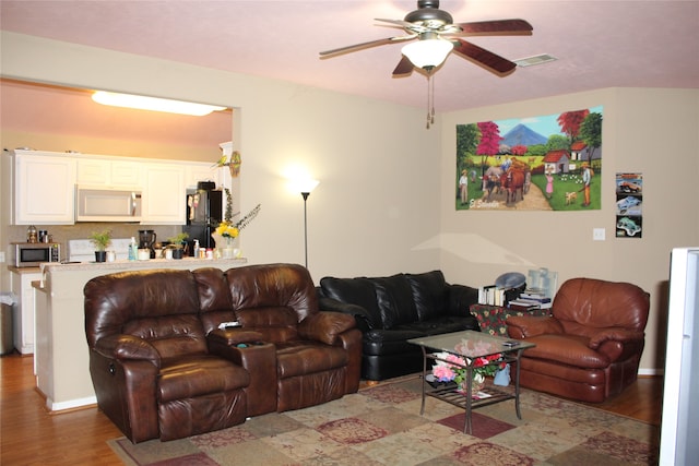 living room with ceiling fan and hardwood / wood-style flooring