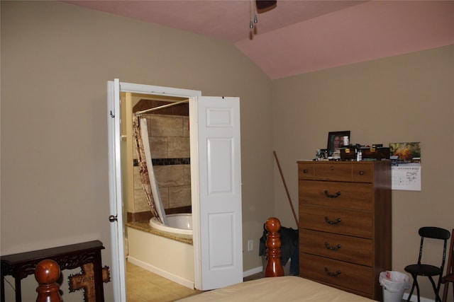 bedroom featuring light tile patterned flooring and vaulted ceiling