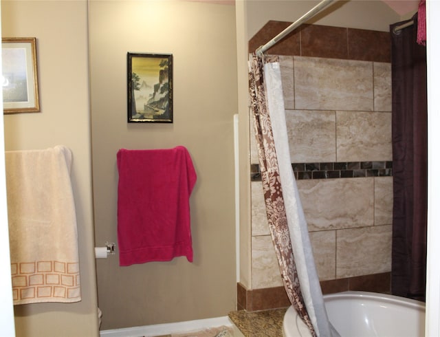 bathroom with toilet and a shower with shower curtain