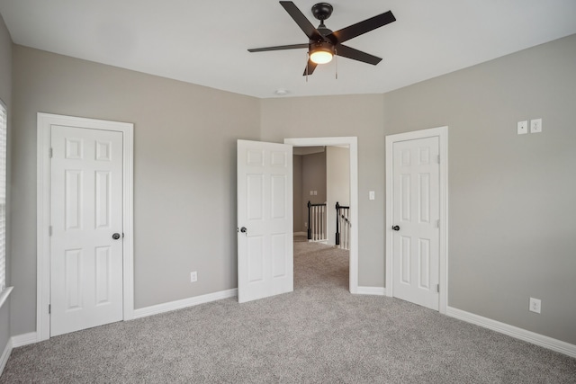 unfurnished bedroom featuring ceiling fan and light colored carpet