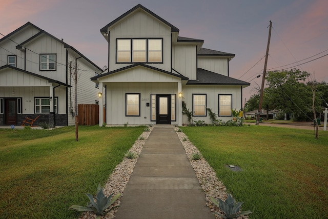 modern inspired farmhouse with a yard