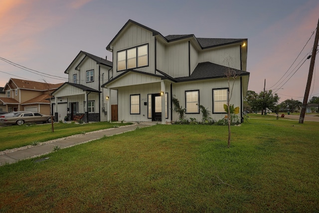 view of front of property with a yard and a garage