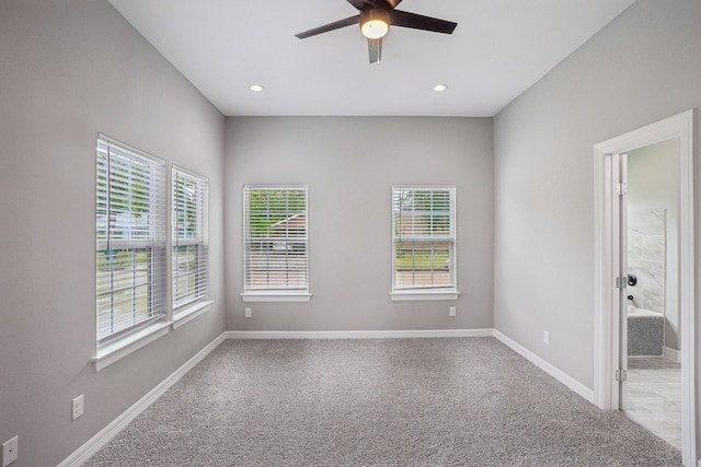 carpeted empty room featuring a wealth of natural light and ceiling fan