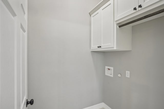 laundry room featuring hookup for a washing machine and cabinets