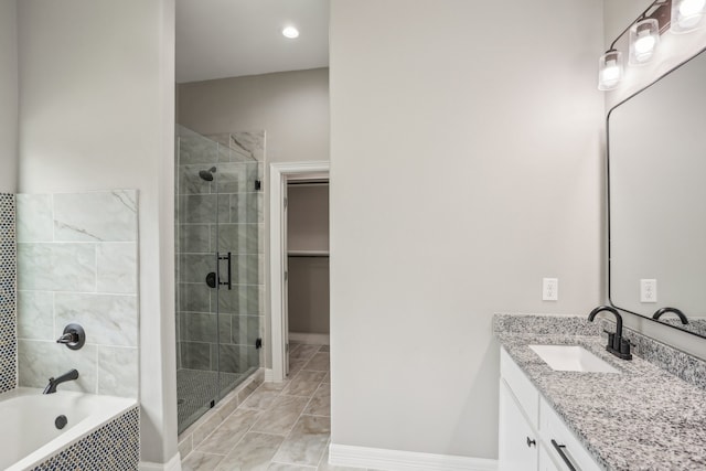 bathroom featuring tile patterned flooring, separate shower and tub, and vanity