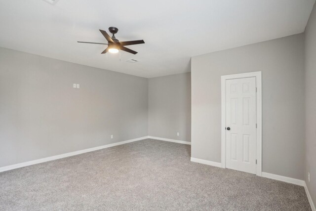 empty room featuring ceiling fan and carpet floors