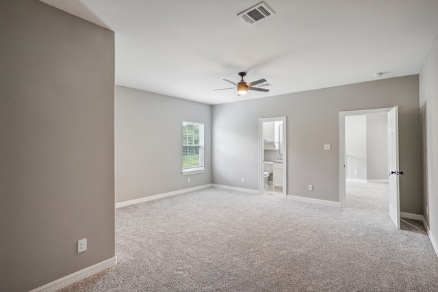 spare room featuring ceiling fan and light carpet