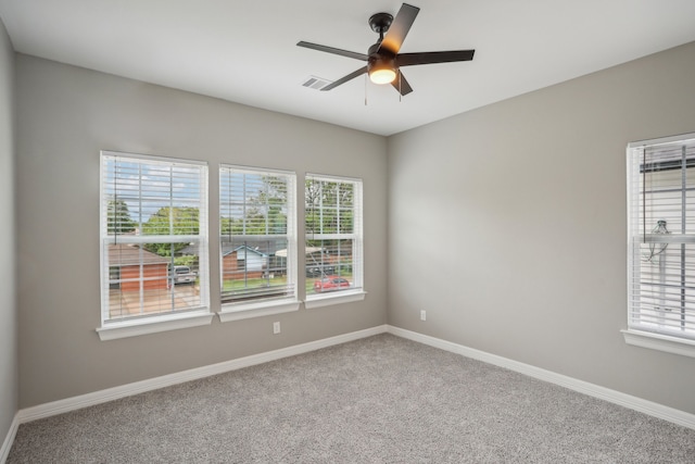 carpeted empty room featuring ceiling fan