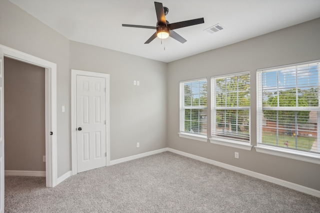 empty room with carpet flooring and ceiling fan