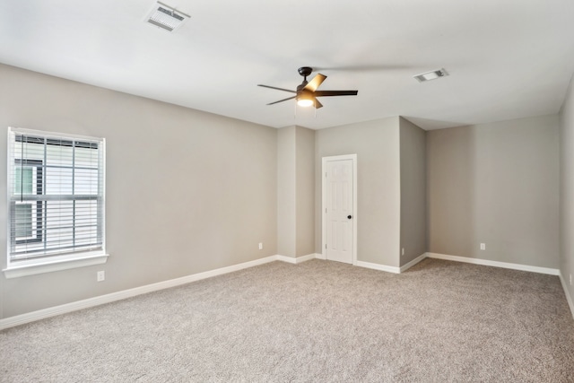 empty room featuring carpet flooring and ceiling fan