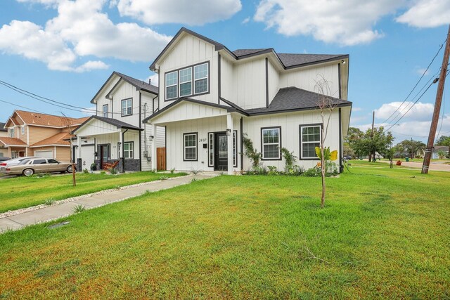 view of front of home with a garage and a front lawn