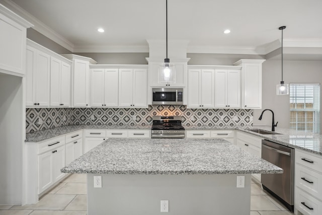 kitchen featuring stainless steel appliances, sink, backsplash, and white cabinetry