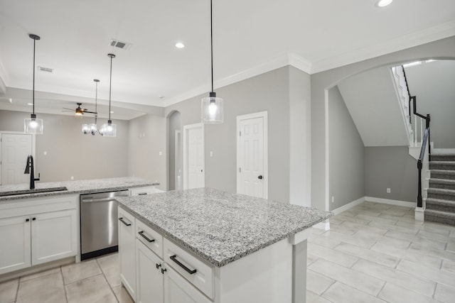 kitchen featuring white cabinets, ceiling fan, pendant lighting, and stainless steel dishwasher