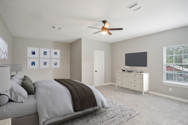 bedroom featuring light carpet and ceiling fan