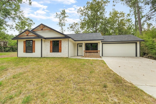 single story home with a garage, a front yard, and covered porch