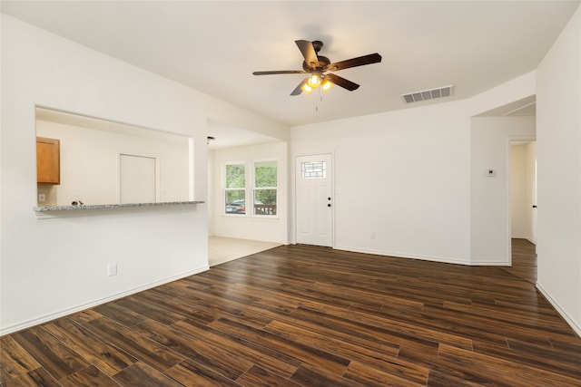 unfurnished living room featuring ceiling fan and dark hardwood / wood-style floors