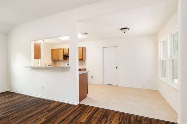 interior space with light stone counters and tile patterned flooring