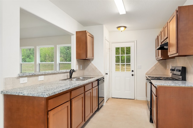 kitchen with decorative backsplash, appliances with stainless steel finishes, and light tile patterned floors