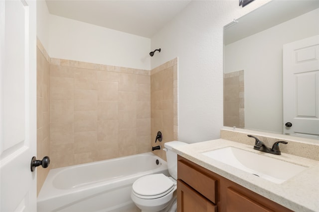 full bathroom with tiled shower / bath combo, toilet, and vanity