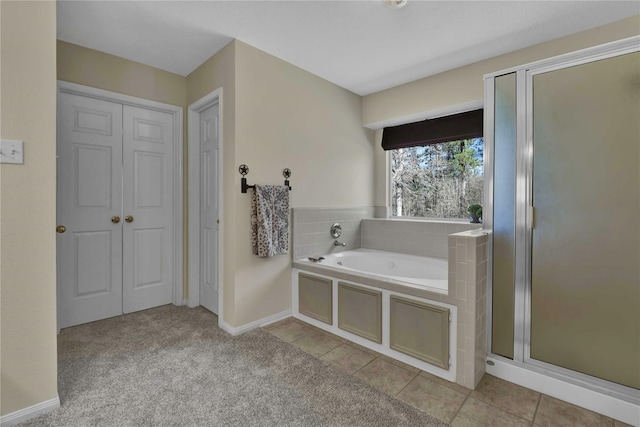 bathroom with tile patterned flooring and separate shower and tub