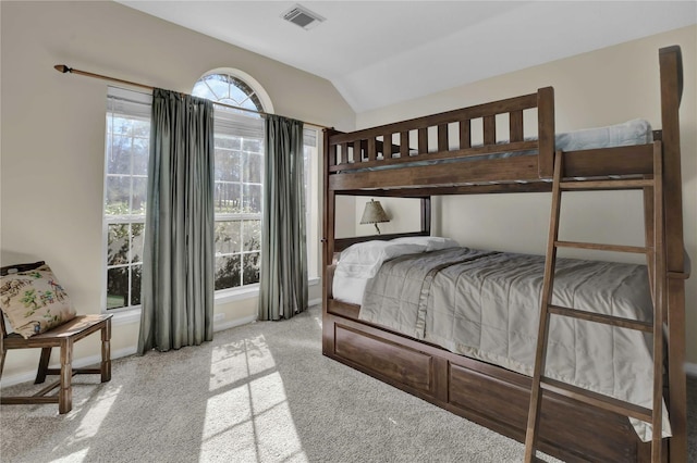 bedroom with light carpet and vaulted ceiling