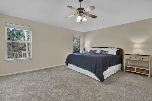 carpeted bedroom featuring ceiling fan and multiple windows