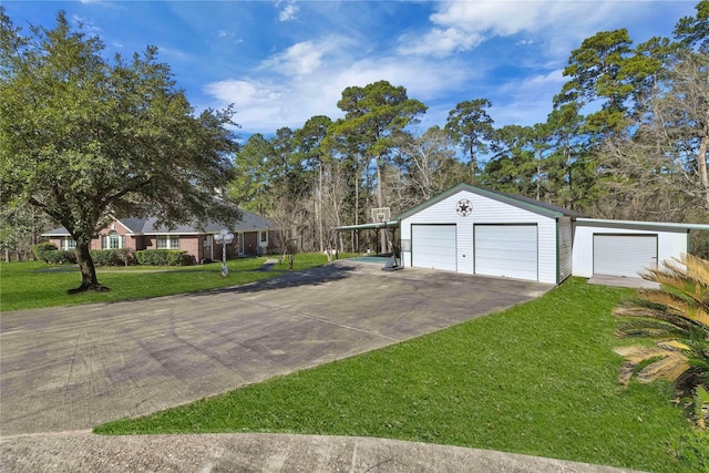 single story home featuring a front yard, an outdoor structure, and a garage