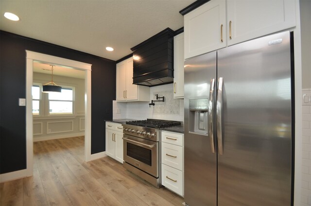 kitchen featuring white cabinets, stainless steel appliances, light hardwood / wood-style floors, and custom exhaust hood