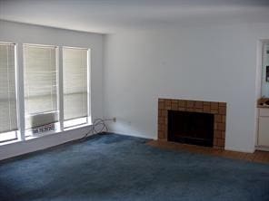 unfurnished living room featuring dark carpet