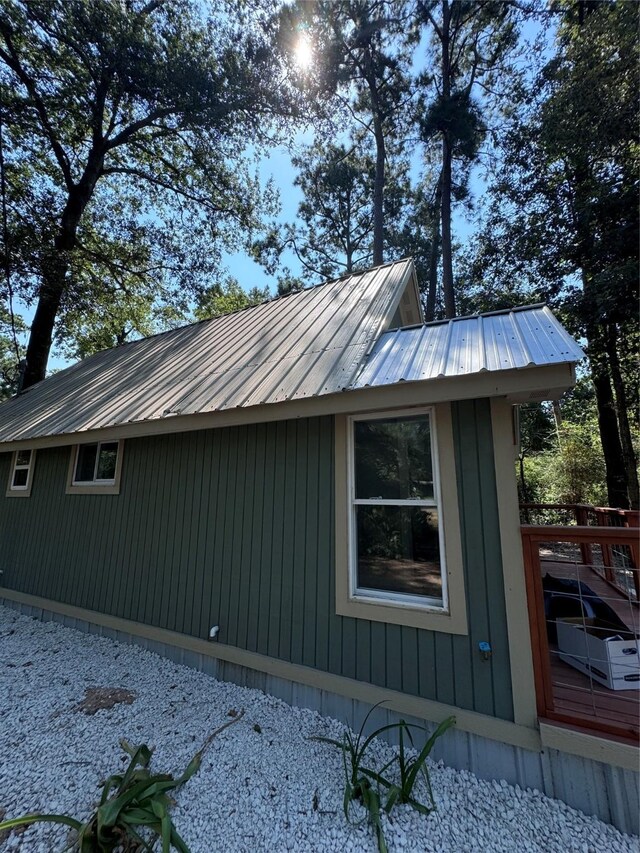 view of property exterior with a wooden deck