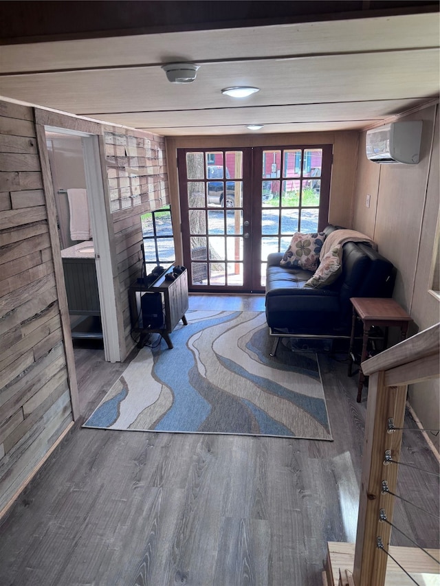 interior space featuring a wall mounted air conditioner, french doors, hardwood / wood-style flooring, and wooden walls