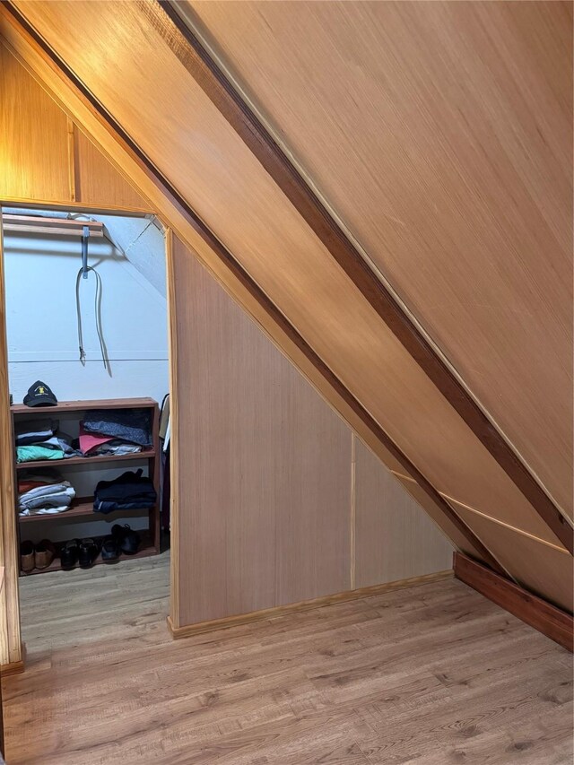 interior space featuring lofted ceiling and light hardwood / wood-style floors