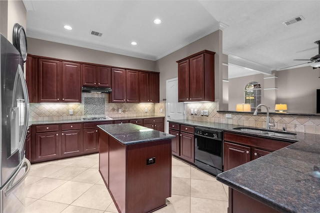 kitchen with a center island, light tile patterned flooring, sink, appliances with stainless steel finishes, and ornamental molding