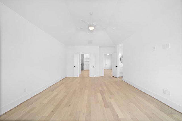 interior space featuring vaulted ceiling, a spacious closet, ceiling fan, and light hardwood / wood-style floors