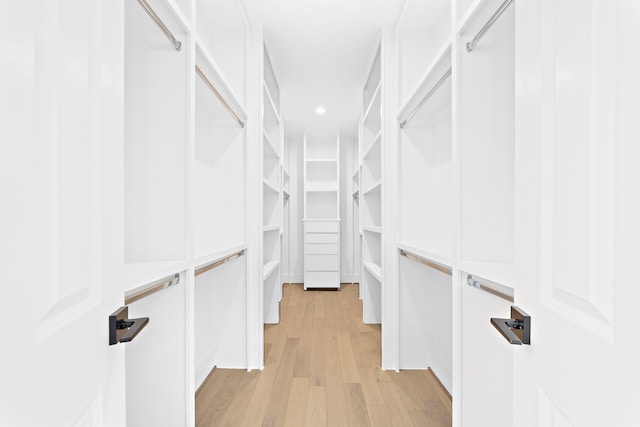 walk in closet featuring light hardwood / wood-style flooring