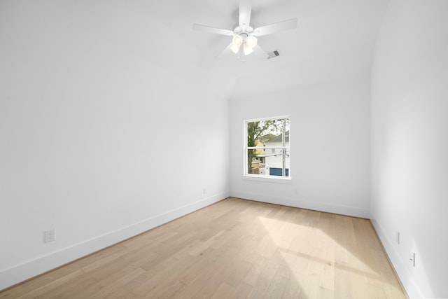 spare room featuring light wood-style floors, visible vents, ceiling fan, and baseboards