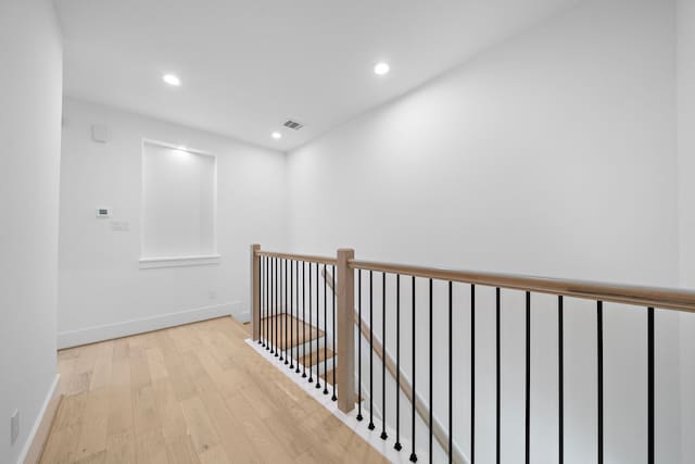 hallway featuring recessed lighting, visible vents, light wood-style flooring, and baseboards