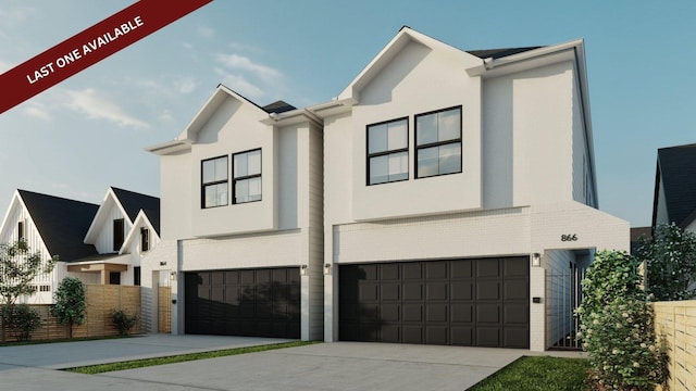 view of front of home with an attached garage, brick siding, fence, driveway, and stucco siding