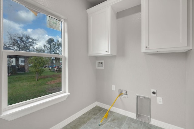 washroom featuring cabinets, light tile patterned flooring, washer hookup, and hookup for an electric dryer