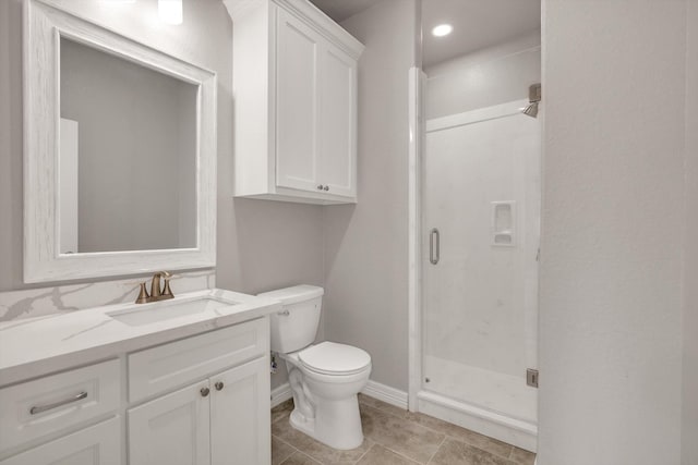 bathroom with vanity, toilet, and an enclosed shower