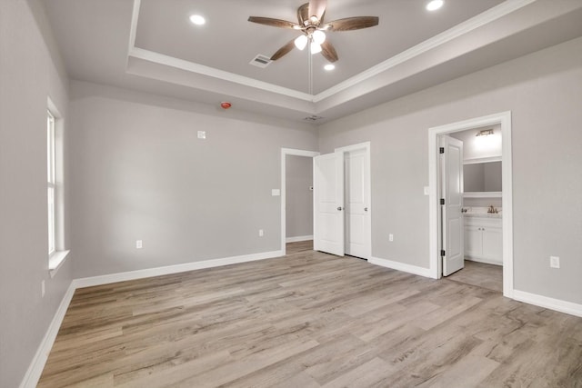 unfurnished bedroom with light wood-type flooring, ensuite bathroom, and ceiling fan