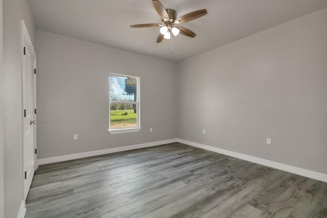 spare room with light wood-type flooring and ceiling fan