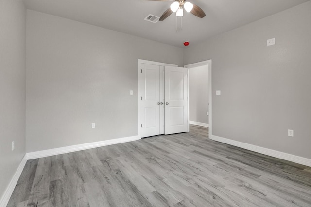 spare room featuring light hardwood / wood-style flooring and ceiling fan